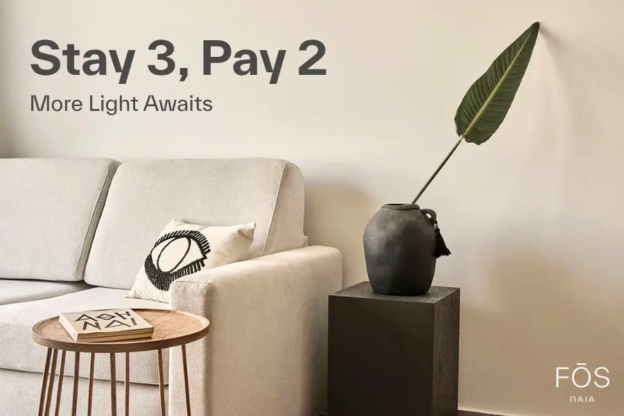 FOS - Stay 3 pay 2 Offer Fos by Naia sunlit luxury suite with warm interiors and balcony, promoting Stay 3 Pay 2 offer for a relaxing extended stay